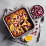 cranberry orange breakfast cake with slice pulled out of pan